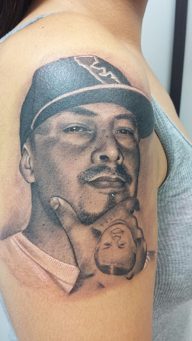 My name is Nicole and I'm 29 years old from Chula Vista. I wanted to express my love for my husband and felt like if I yelled it at the top of a mountain, it wouldn't be good enough. I went a step further & got his portrait instead. Now that's LOVE! Haha Work done by Chuy Espinoza of Vital Lines Tattoo in Ocean Beach. Check him out, you won't be disappointed! 