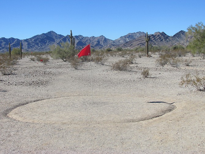 Desert Golf is played a little different than at Torrey Pines. A ball landing inside the sandy circle counts as in the cup. 