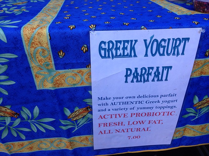 To find the yogurt stand, look for a bright Mediterranean table cloth, and this sign.
