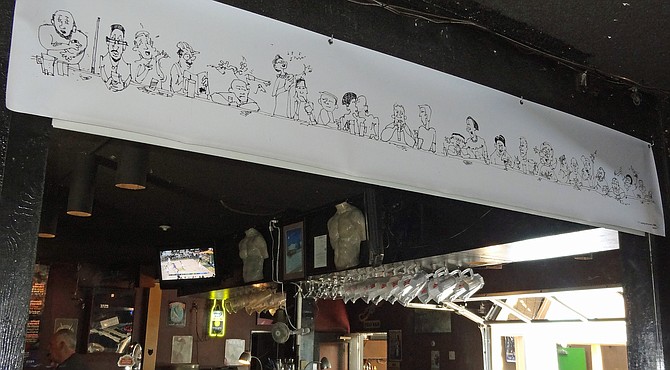 I went by Pecs Bar on University Avenue in North Park today, and took a photo of a new banner created by North Park artist Trevor Copenhaver. It's all caricatures of the bar regulars at Pecs. 