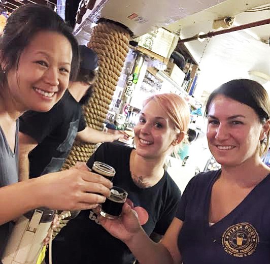 Eagle Rock's Ting Su (left), Keep A Breast Foundation's Melanie Pierce (center), and Pizza Port's Devon Randall unwind after a busy collaboration brew day.