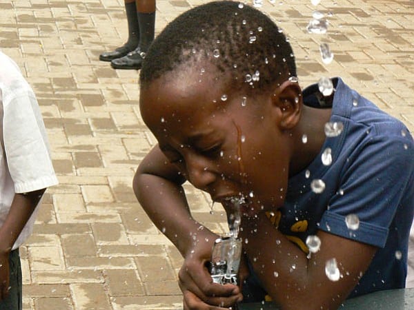 A Zulu schoolboy drinking water in Johannesburg, South Africa. 