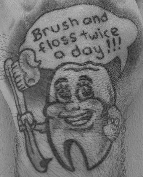 Hello there, my name is DJ.  My Dentist gave me the idea for this tattoo.  She recommended that I get it as a reminder of good ole fashion oral hygiene.  She laughed at her own idea, but this photo is now framed in her office and my teeth are a shinning beam of gloriousness.  The tooth guy: tattooed by Droopy of Tattoo Royale San Diego!!!