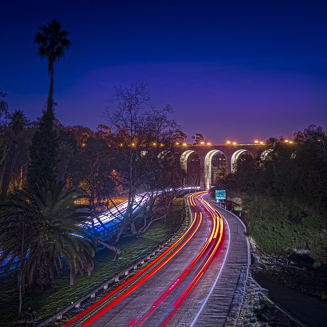 Just after sunset looking south towards the end of Hwy 163 at Cabrillo Bridge in Balboa Park
🔸For people not familiar with this Bridge:
It's a 2 lane, 120 ft high, 450 ft long Bridge above Cabrillo Canyon which is the pathway of highway 163, a 2 lane highway each direction going through the arches & it's considered one of America's most beautiful highways. The bridge connects the south and north sides of Balboa Park.
🎆On New Years Eve, celebrating the 100th year anniversary, the new lights under the arches were turned on!
🔹3 shot HDR, photo realistic
