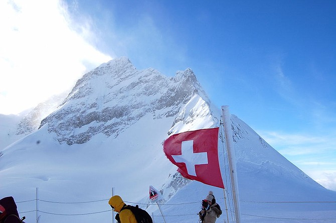 The wind whipped Swiss flag flutters at the Jungfrau's Plateau vantage point.