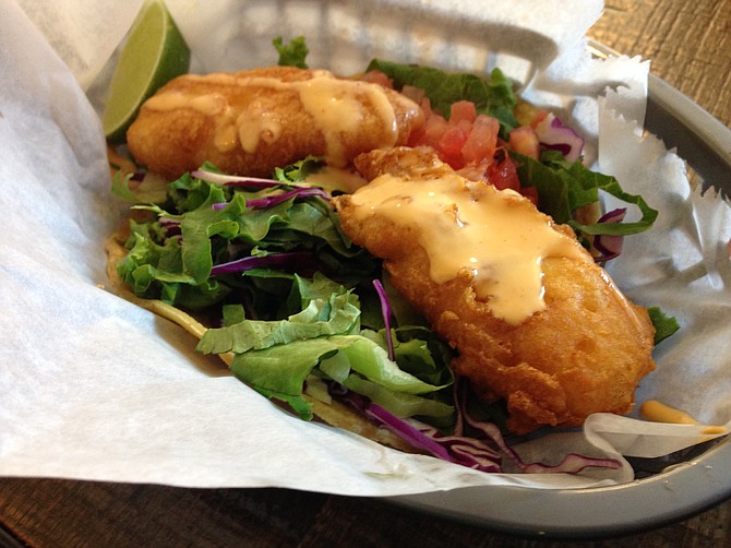 Well-fried cod, I just wish that sauce had some flavor to it. Fried cod taco. Fish District.