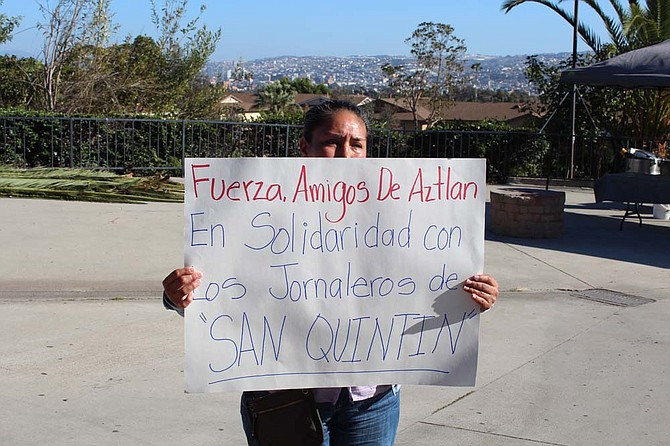 San Ysidrans stand in alliance with families of missing Ayotzinapa students. Tijuana is in the background.
