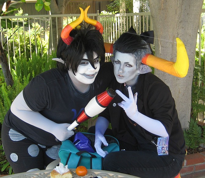 2 cosplayers hanging out in the pool area.