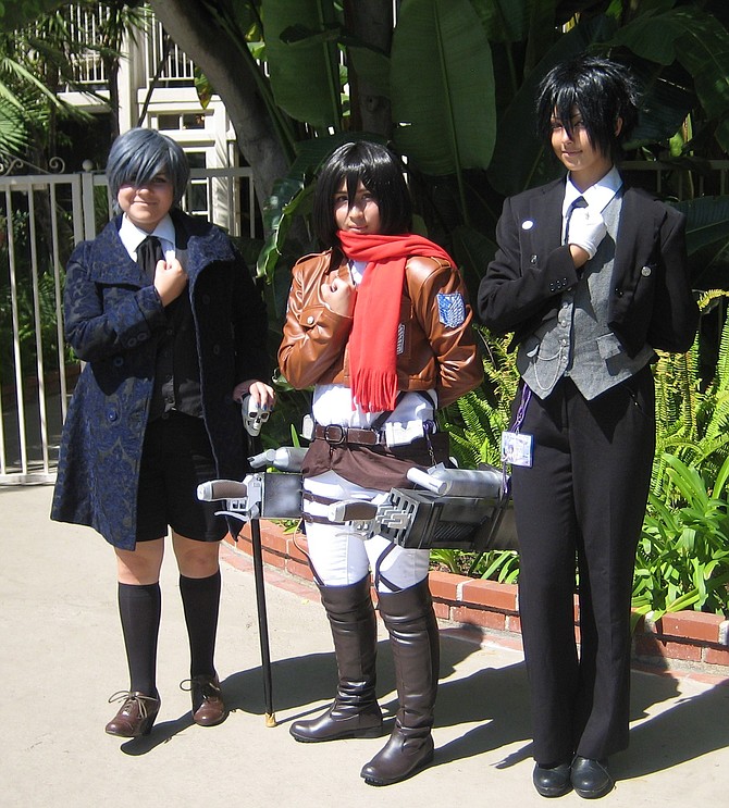 The woman in the middle is potraying a character from Attack on Titan.