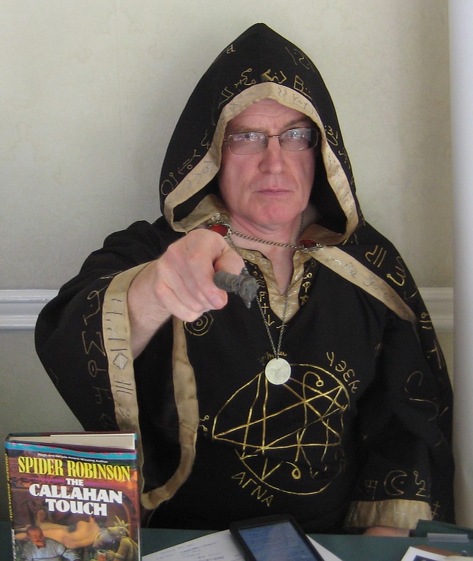 James H. Hay cosplaying at table for Westercon 68