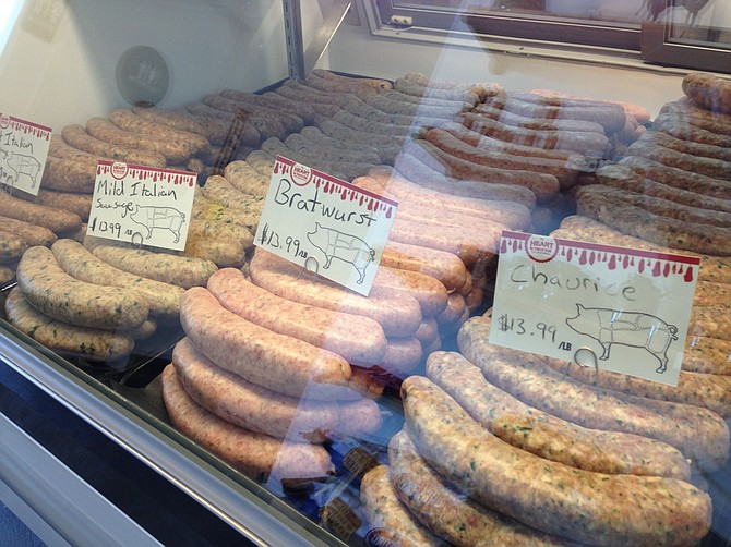 The sausage counter gives these butchers a chance to show their way around a grinder and spice rack.
