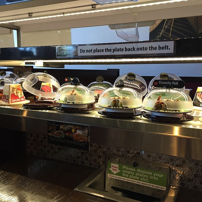 The conveyor belt, Mr. Fresh-contained sushi, and plate slot