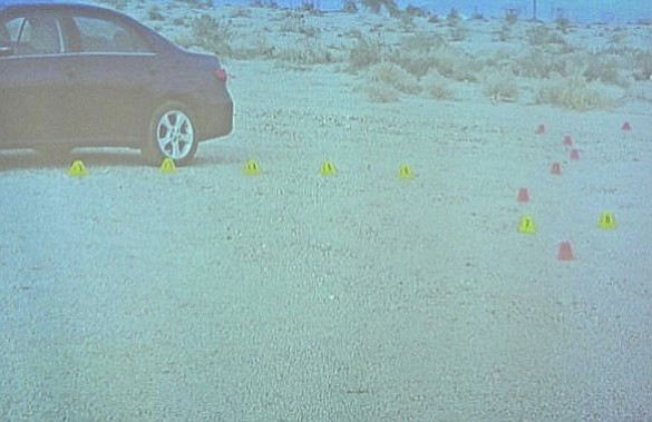 Evidence photo shown in court of Erin's car  (footprints and tire marks indicated by markers)