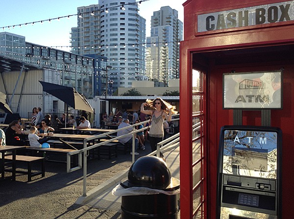 English phone booth ATM in front of the Quartyard bar