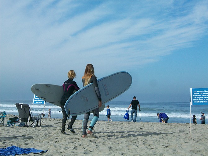 Surfers hit the waves at Mission Beach.