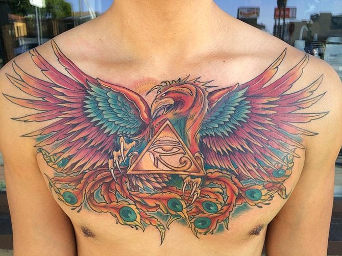 My name is Marco and I live in Bay Park. I am an entrepreneur that also works in Finance. I had this tattoo done by Mike Sirot, who owns a shop in University Heights named Eden Tattoo. I chose to have a Phoenix with the eye of RA within a 1 dimensional pyramid because of its symbolism. The Phoenix is a mythical creature that cannot die, it is merely reborn after every lifetime. They eye of RA within the 1 dimensional pyramid are symbol of power, protection, and prosperity. This was just completed to day and couldn't be happier with the results. This truly is a work of art that should be best tattoo.