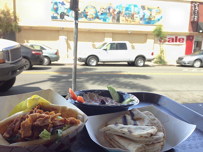 Chicken shawarma sandwich and baba ghanoush, served with a view of OB, kind of
