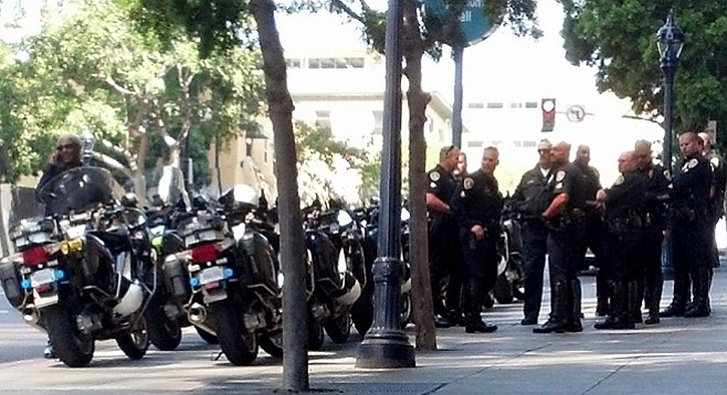Police gathered in anticipation of a surge of protesters marching through downtown streets
