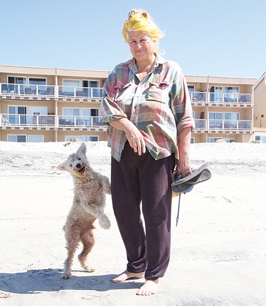Rina Kelley and her dog Sparky were attacked by an unleashed pit bull on the sand at Imperial Beach.