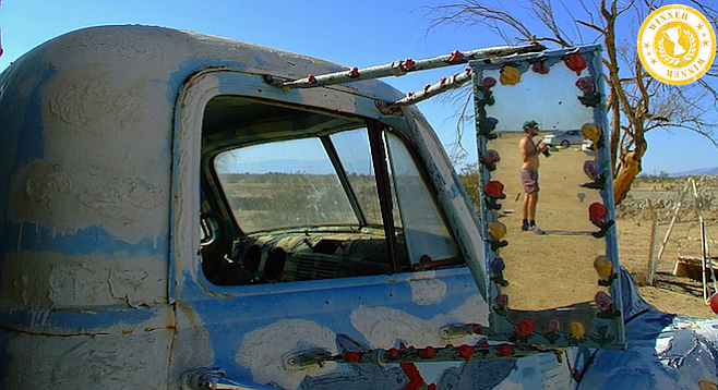 Man in the mirror at Salvation Mountain.