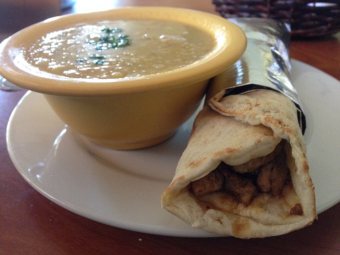 A bowl of dry soup and a tasty chicken shawerma wrap