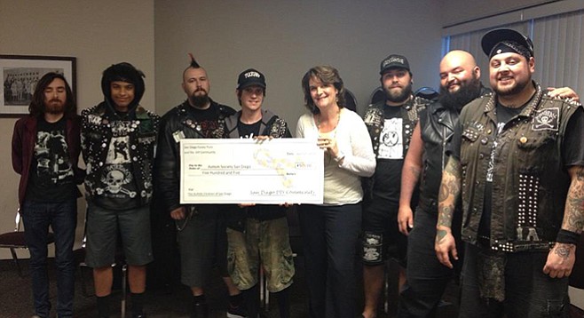 DIY show promoters the Pyrate Punx present a big check to local autism chapter.
