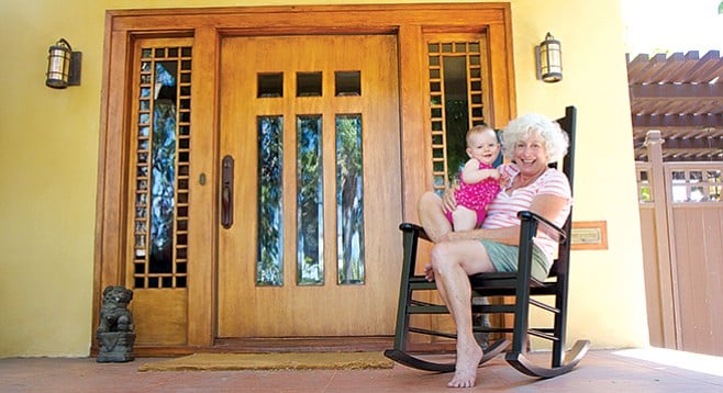 Rachel Smith with her granddaughter in front of her historic home - Image by Howie Rosen