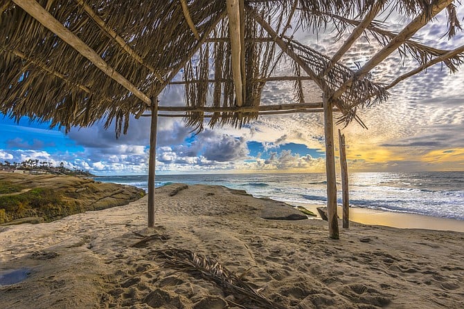 Beneath the surf shack at Windansea Beach amidst a vibrant sunset.