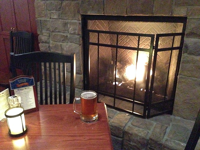 A large mug of the great Alpine Duet IPA, next to the fireplace.