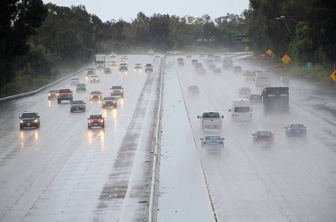 Cars driving on the freeway during rain storm - shot from an overpass