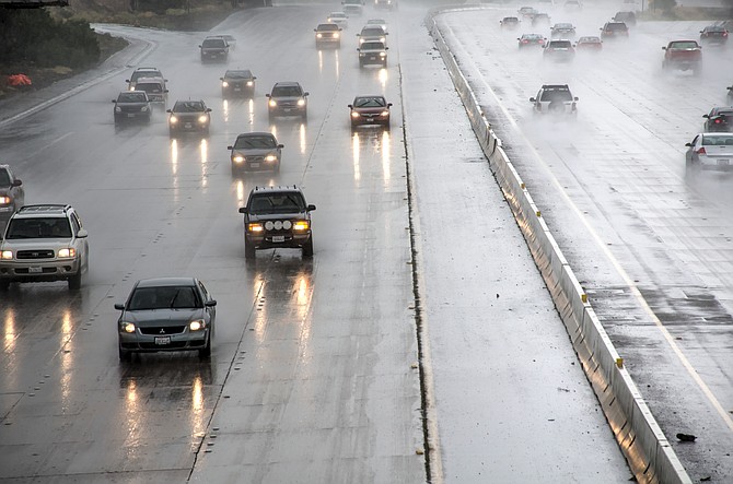 Cars driving on the freeway during rain storm - shot from an overpass
