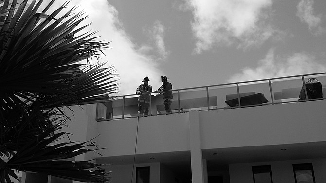 Firefighters at Saratoga apts. Not sure why it came out black and white. Smoke damage on building behind them. 
