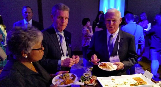 Joe Terzi (upper left) stays in the background as Paul Robinson and Ron Roberts snack in Japan
