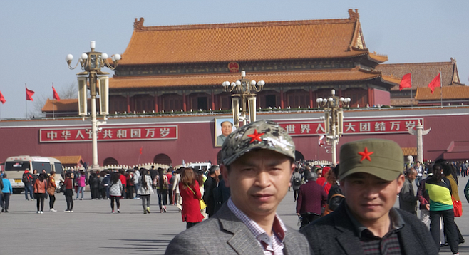 Locals pose for a shot on Tiananmen Square.