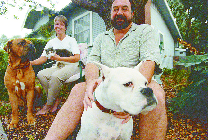 Janice and Rod Owlett with Sam, Tramp, and Opal. Taking the dogs to Grape Street for their run, Janice cut through the Olive Street alley and saw a real estate agent putting up a For Sale sign in front of a house.