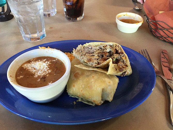 Carnitas burrito. All dishes come with seasoned rice and beans.