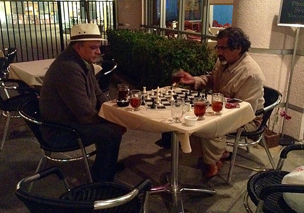 Fieq the philosophy professor plays late-night chess with a fellow customer