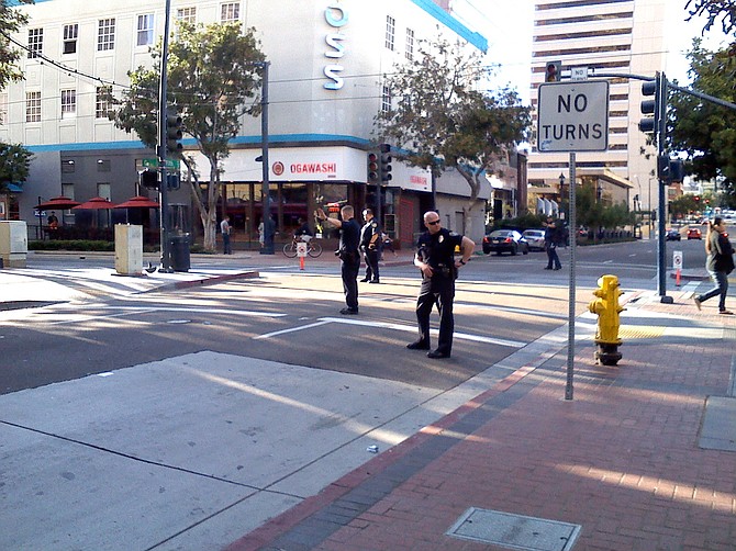 Police officers controlling traffic at 5th and C Streets