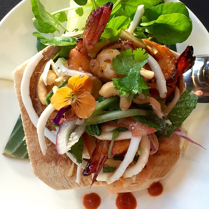Grilled prawn salad in a coconut shell