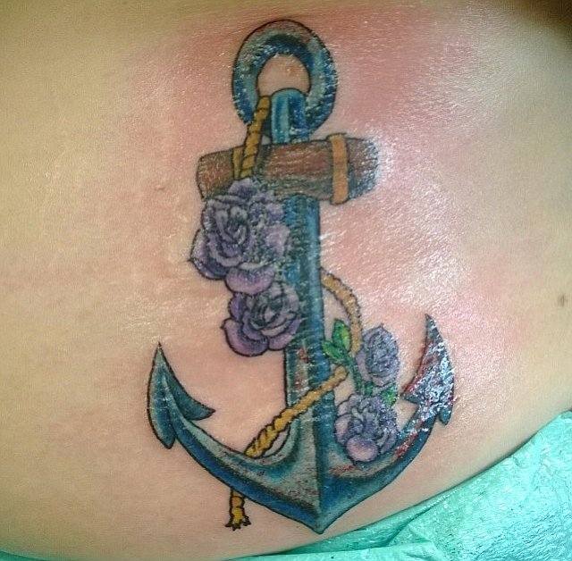Growing up near the ocean, it's probably not hard to imagine why I picked an anchor. I've been a swimmer since 2nd grade. My parents used to call me their fish, because I was always first in, and last to get out. I believe in steadfastness in all things, which is what the anchor represents to me. It's surrounded by 4 flowers, and there are 4 members of my immediate family. They keep me grounded. I think of these song lyrics when I look at it- "You be the anchor that keeps my feet on the ground, and i'll be the wings that keep your heart in the clouds." I got this tattoo at Allegory tattoo in San Diego and I couldn't be happier with Pete's work. 