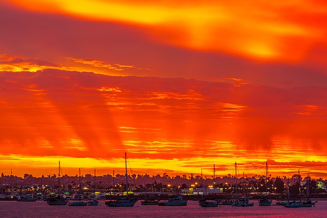 The San Diego Bay and Point Loma amidst a incredibly vibrant sunset.