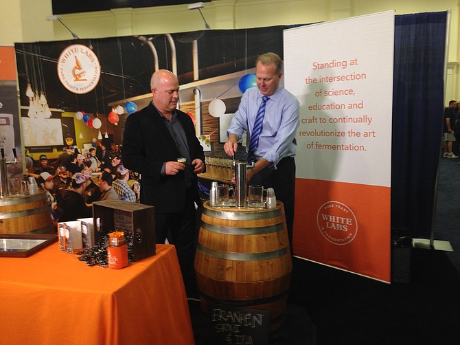 Mayor Kevin Faulconer pours White Labs beer for attendees of June's National Homebrewers Conference, while White Labs CEO Chris White looks on.