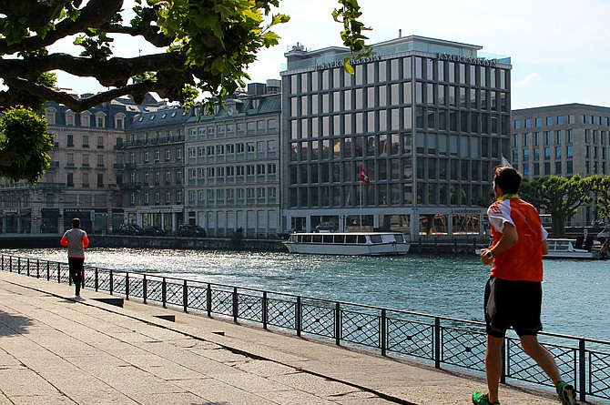 Early morning joggers, bikers and old ladies make up the banks of the Rhone River where it flows from the lake to the Mediterranean