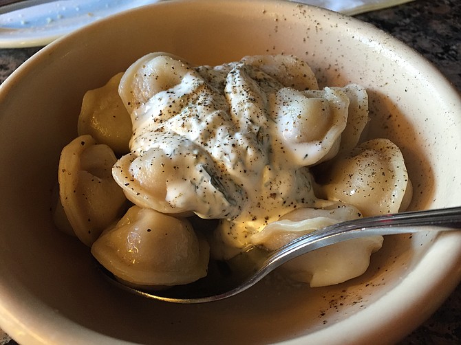 Pelmeni, meat dumplings with yogurt-dill sauce