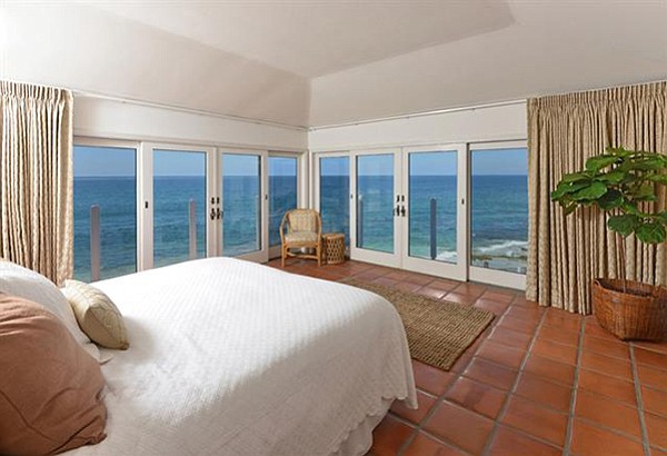The master bedroom has two oceanfront window walls and access to a wrap-around deck.