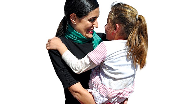 Jacqueline Isaac holds a Yazidi child on Mount Sinjar in Iraq