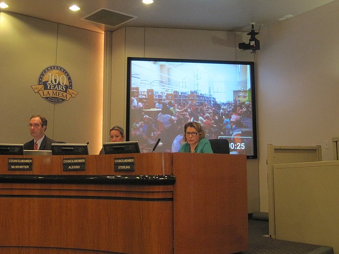 La Mesa City Council members (photo of crowded library in background)