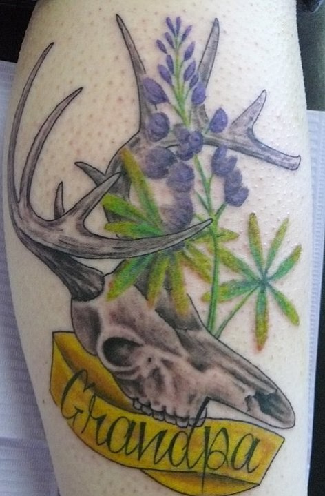 This is a very important tattoo to me, as it is a memorial tattoo in honor of my late grandfather, Doug. The deer skull is because he was an avid hunter, and the lupine was his favorite flower. The lupine is colored purple because it was one of the few colors he could see, since he was color blind. I got the tattoo in Potsdam, NY at Beyond Tattoos, and it was done by Scott Dafoe. I'm originally from northern NY but I currently live in Oceanside, CA. I'm 23 years old and I'm a bakery clerk at Vons.