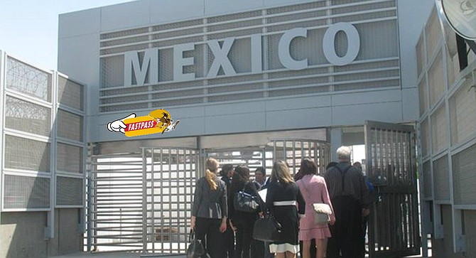 Pedestrians wait in line to pass through Mexico's new East Gate facility, apparently unmoved by Speedy Gonzales' promise of available rapid entry.