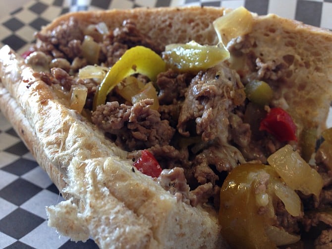 Cheesesteak on a wheat roll with grilled onions and peppers and per recommendation, a little mayo